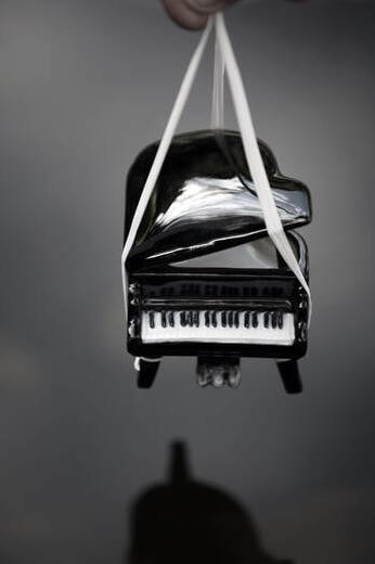 piano being hoisted in air for moving